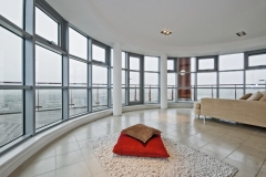 luxury modern penthouse apartment with floor to ceiling windows and panoramic views
